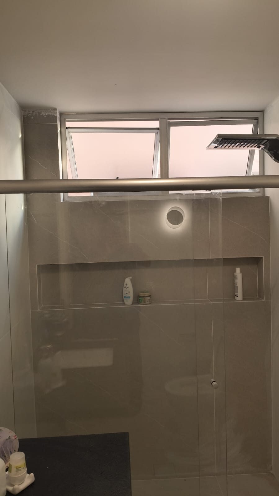 Box de banheiro em apartamento de luxo em Belo Horizonte, com porcelanato de grande formato, nicho embutido e ducha de teto, obra da Apus Construtora